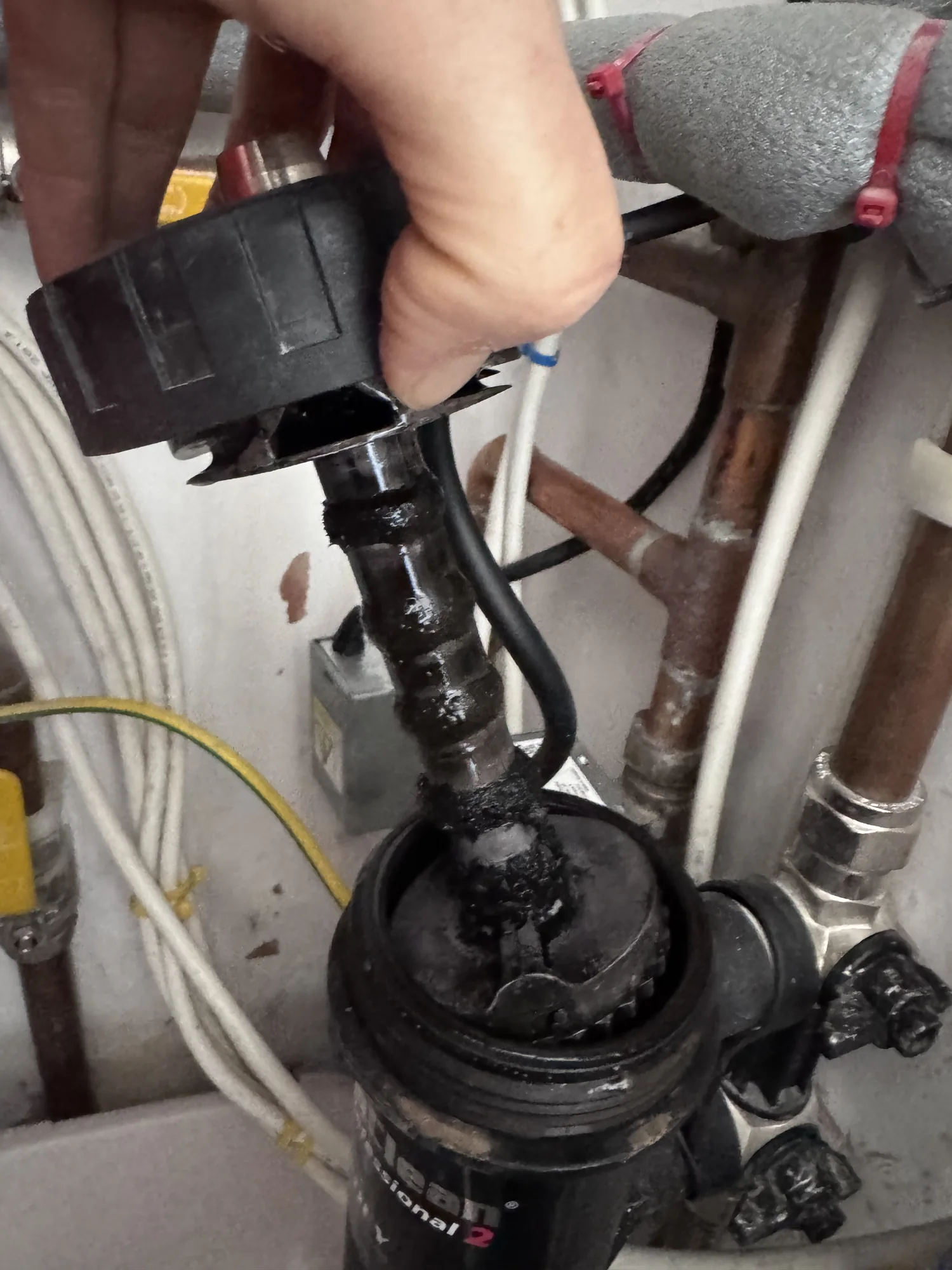 Power flush hose connected to a heating system with the flushing machine in shot