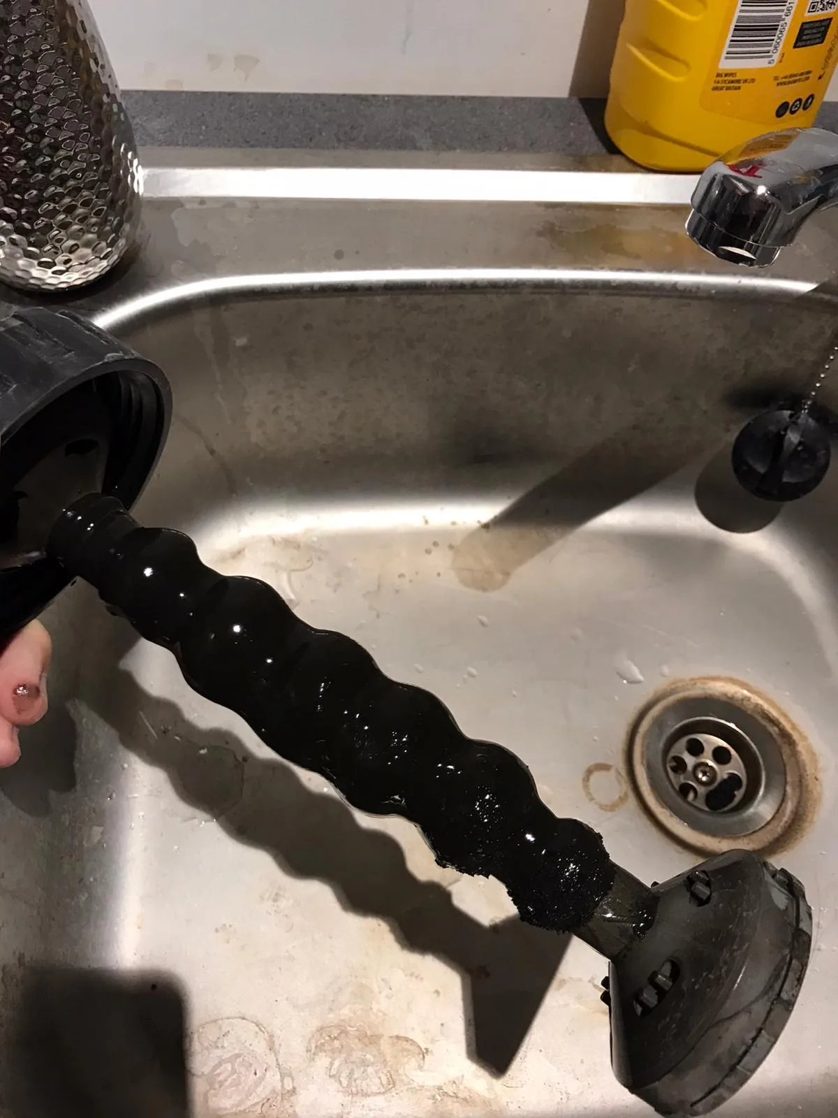 Thick black sludge removed from a heating system during a power flush
