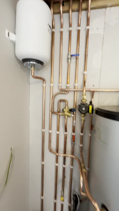 Walkthrough of a completed heating system installation: boiler, hot water cylinder and copper pipework